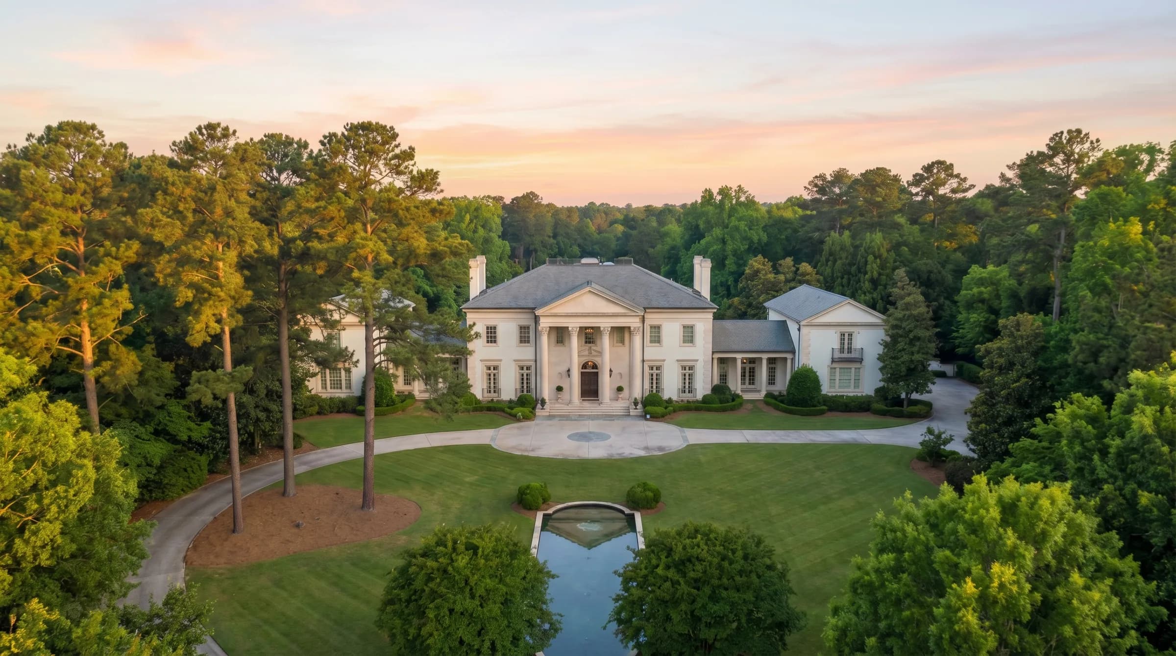Buckhead courtyard home with formal architecture, symmetrical facade, and sculpted plantings.