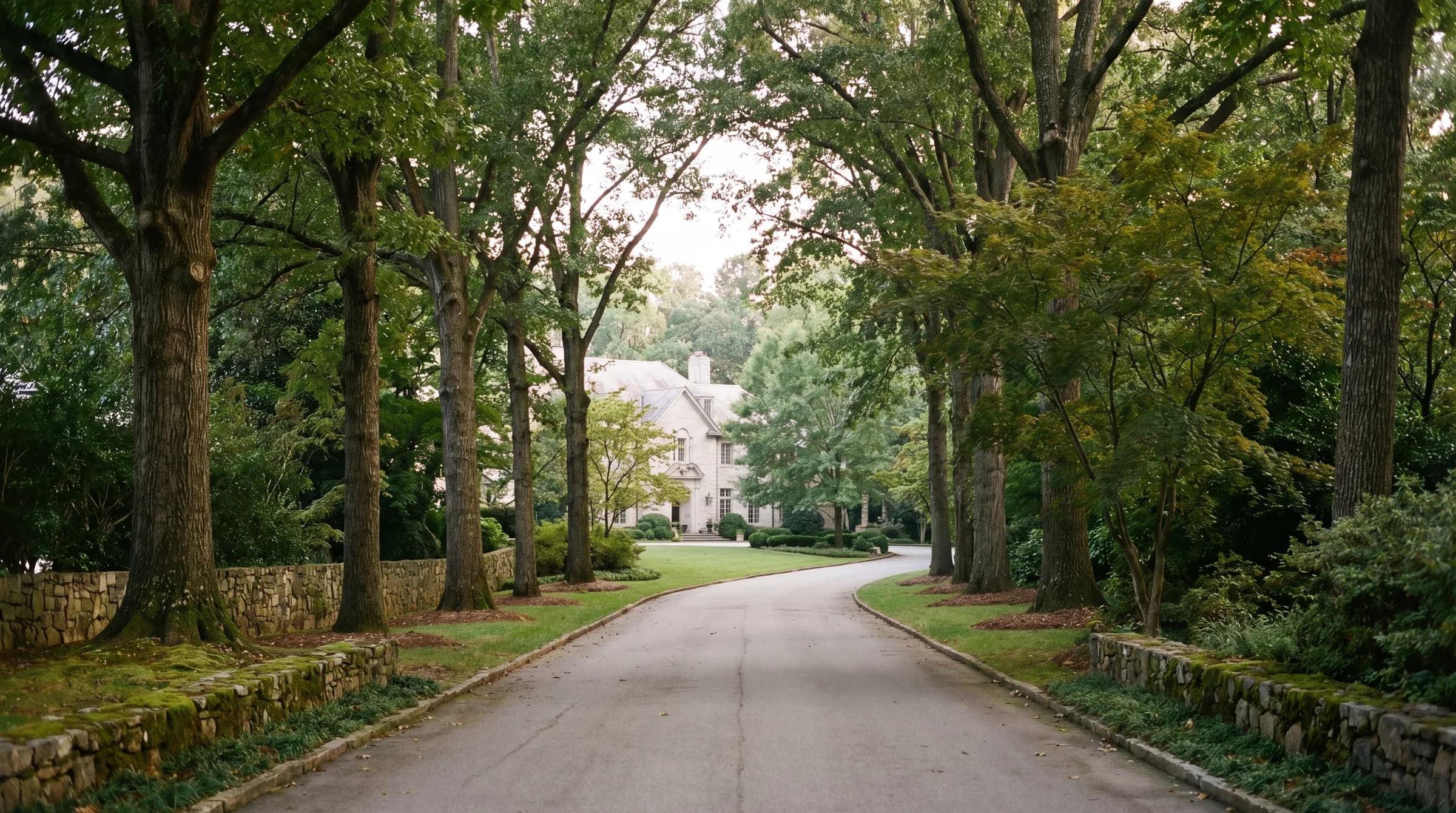 North Atlanta classic residence with manicured lawn and landscaping in bright daylight.